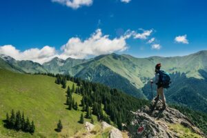 man-hiking-with-backpack-in-the-mountains-summertime