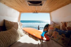 van-parked-at-beach-with-surfboard